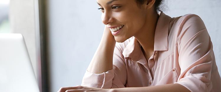 A woman looking at a laptop