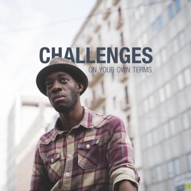 Young man with a hat on a city street. The text behind him reads "Challenges on your own terms."